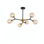 Bubble orb chandelier with 5 clear glass globes, black arms, and brushed gold hub