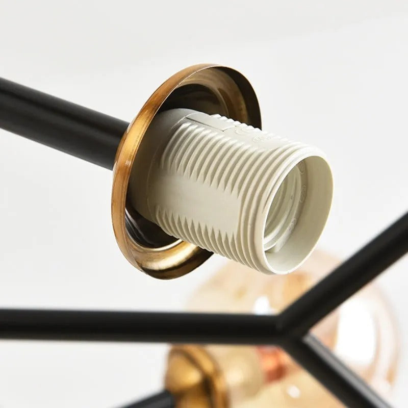 Bubble orb chandelier socket detail: black arm with gold rim and ribbed white bulb holder
