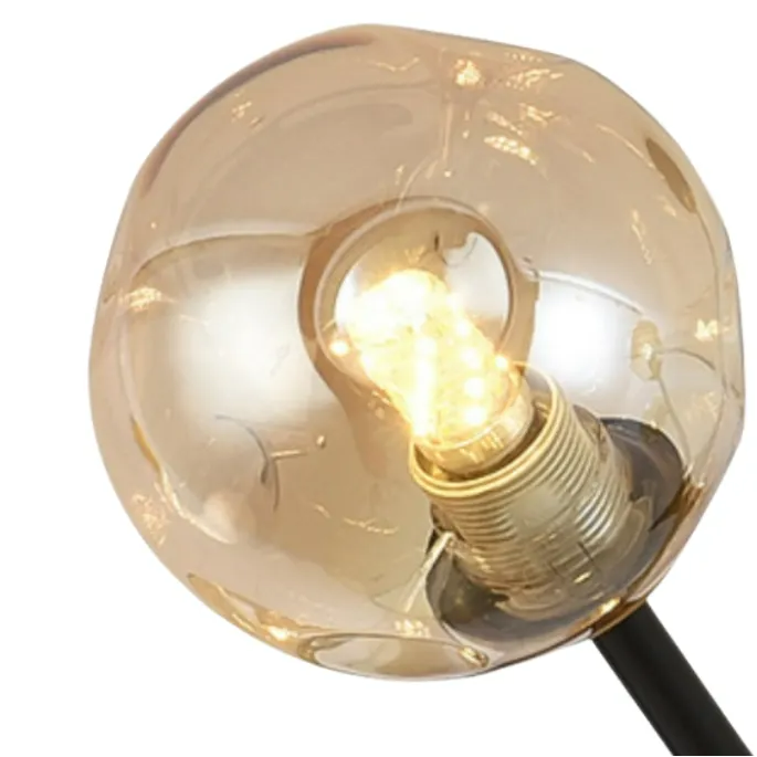 Clear amber-tinted glass orb with visible warm bulb and gold lamp holder