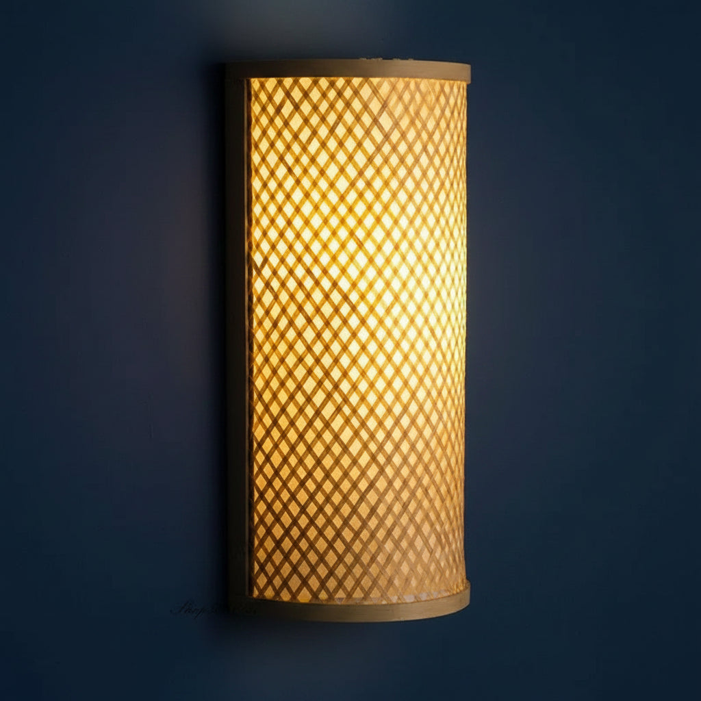Bamboo cylinder wall sconce with woven lattice shade and dark mounting bracket
