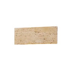 Rectangular travertine wall light sconce with textured stone faceplate, unlit