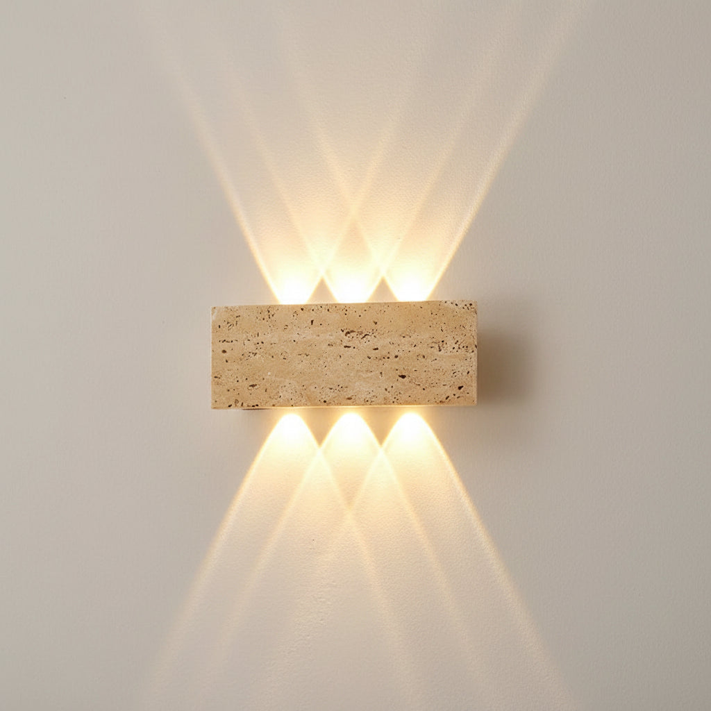 Rectangular travertine up-and-down wall sconce emitting warm light