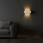 Rectangular travertine wall sconce with warm light lines, up and down
