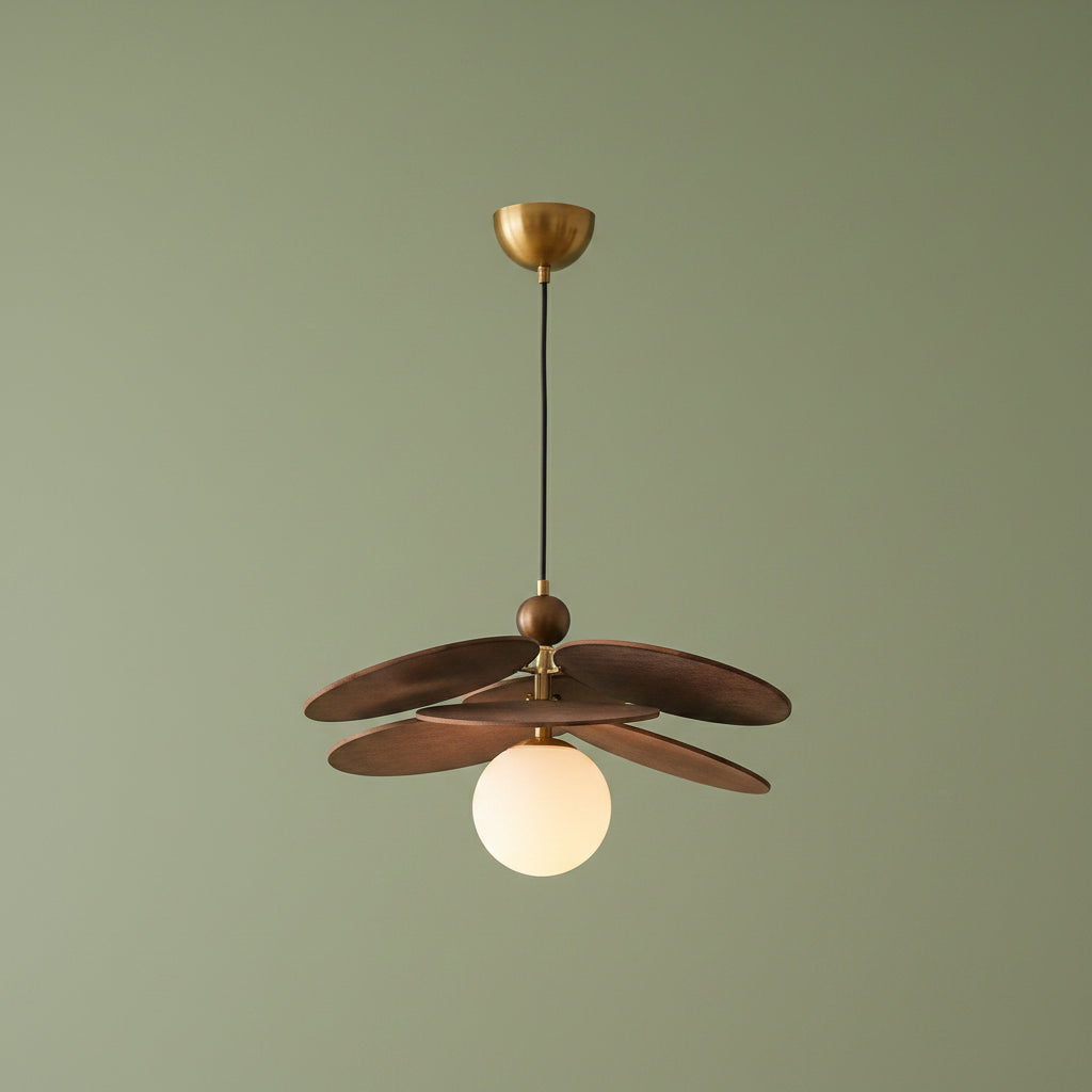 Opal globe pendant light with brass cap, dark fan arms, and single opal glass globe