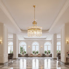 Gold-framed tiered crystal prism hanging light with drum-shaped chandelier shade