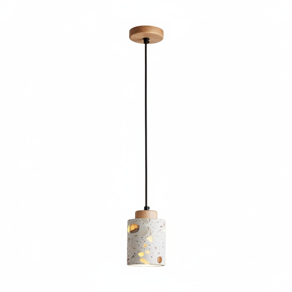 Terrazzo cylindrical pendant light with wooden top plate and speckled drum shade.