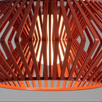 Red lattice chandelier shade with diamond pattern and glowing bulb from within