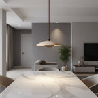 Round Scandinavian pendant light with travertine dome and wooden core, hanging above table