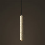 Gray speckled cylindrical pendant light with black cord and downlight bulb.