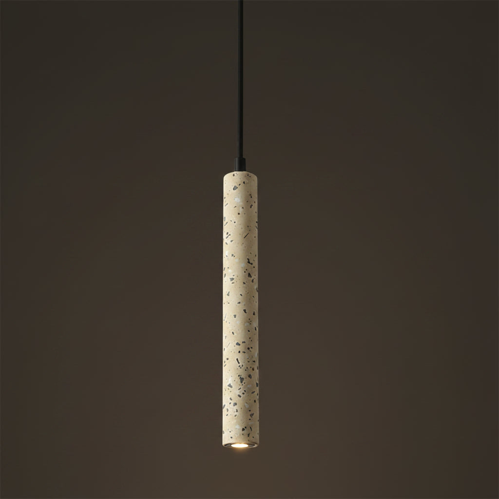 Gray speckled cylindrical pendant light with black cord and downlight bulb.