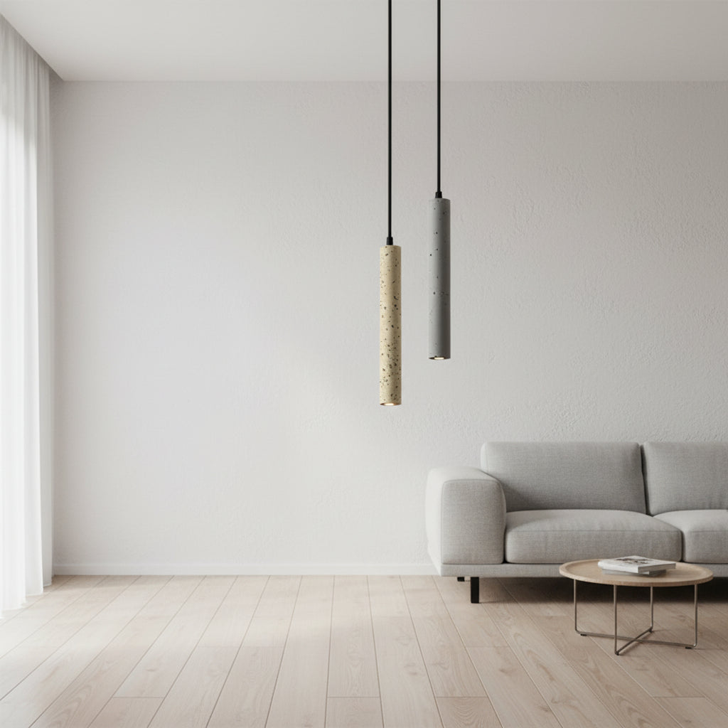 Two speckled cylindrical pendant lights: cream and gray on black cords.