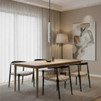 Cream speckled cylindrical pendant light with black cord and warm white glow.