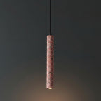 Red speckled cylindrical pendant light with black cord and downward light.