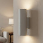 Cylindrical concrete wall light with sand white finish and side-mounted bracket
