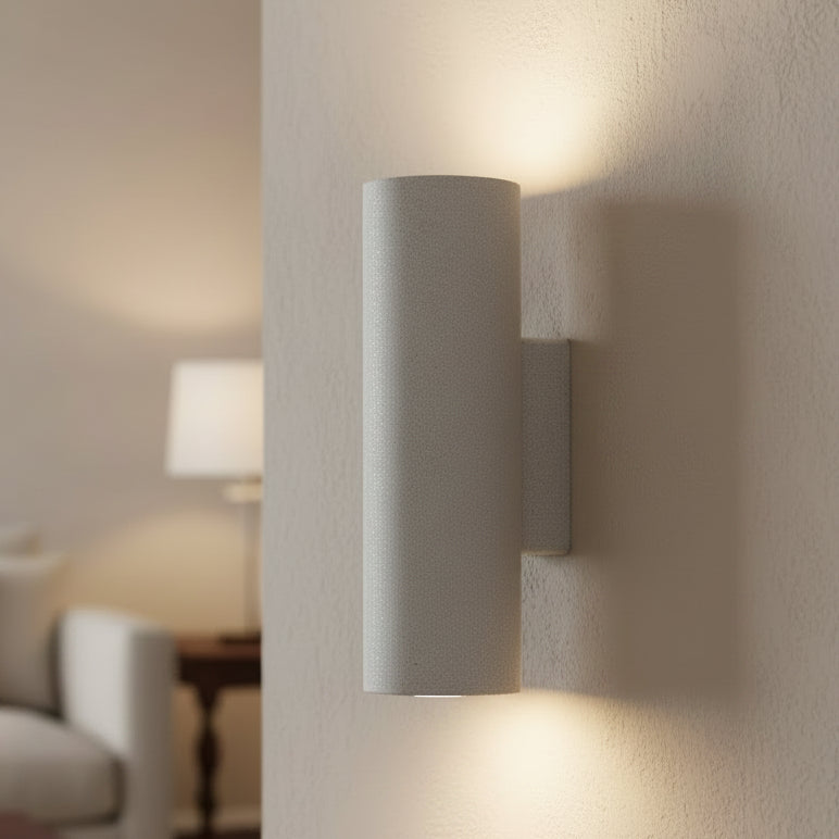 Cylindrical concrete wall light with sand white finish and side-mounted bracket