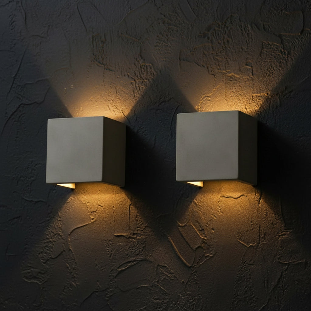 Pair of square concrete wall lights with white diffusers on wall