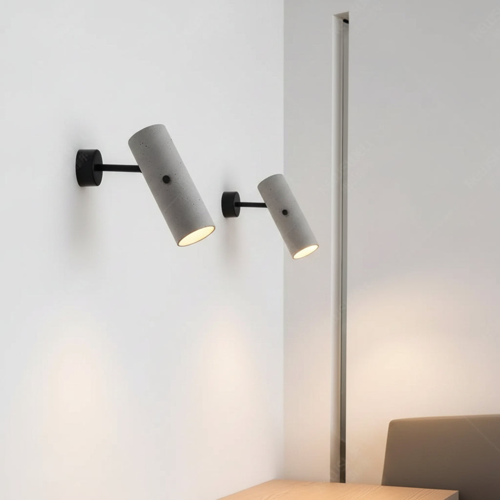 Wall-mounted set of three tubular rotatable lights, grey speckled cylinders, black mounts