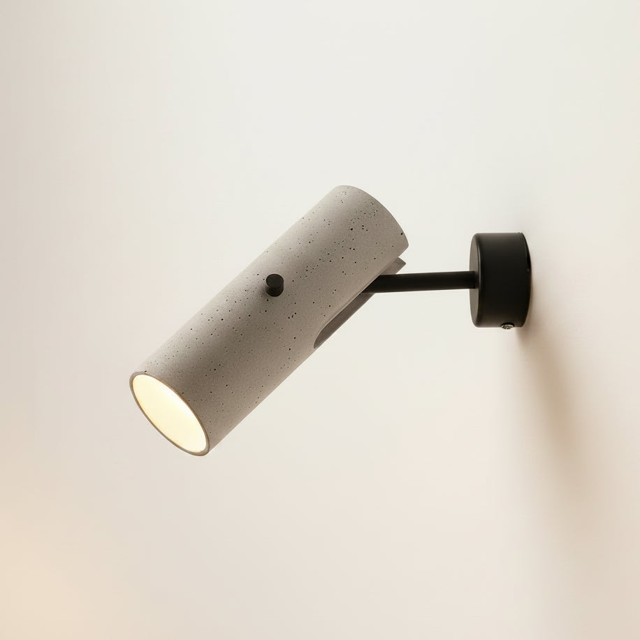 Rotatable tubular wall light with grey speckled cylinder, black round backplate, downlight