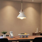 Pendant light with white cone shade and gray concrete canopy, single brass hanging cord