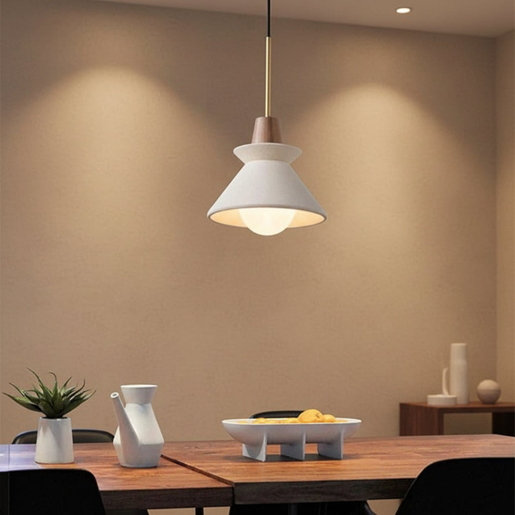 Pendant light with white cone shade and gray concrete canopy, single brass hanging cord