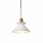 Pendant light with white cone shade and gray concrete canopy, brass hanging cord