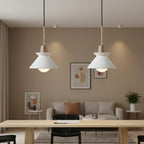 Pair of pendant lights with white cone shades and gray concrete canopies, brass cords