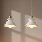 Pendant light with white cone shade and light gray concrete canopy, brass cord