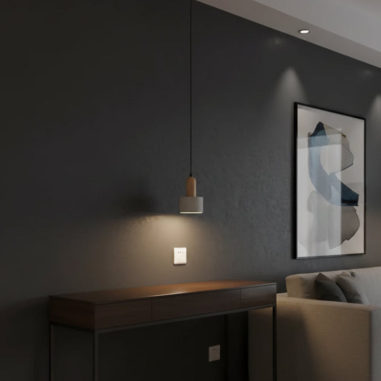 Cylinder pendant light with beige shade and black cord