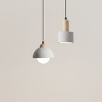 Cylindrical pendant light with gray shade and cork cap, black cord