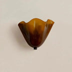 Amber scalloped wave glass wall light with black mounting cap and single bulb base