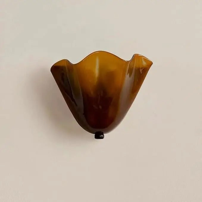 Amber scalloped wave glass wall light with black mounting cap and single bulb base