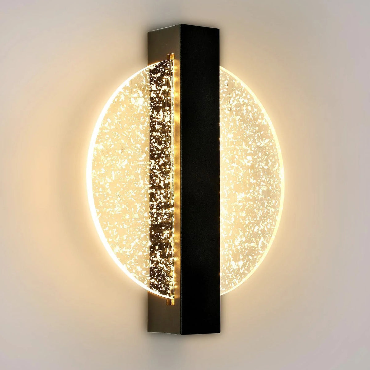 Wall sconce with tall black center bar and large warm glowing bubble backlit disk