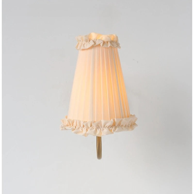 Ruffled fabric lampshade with pleated body and short wall mount stem