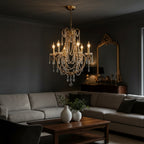Gold-tone candle chandelier with curved arms and hanging crystal chains