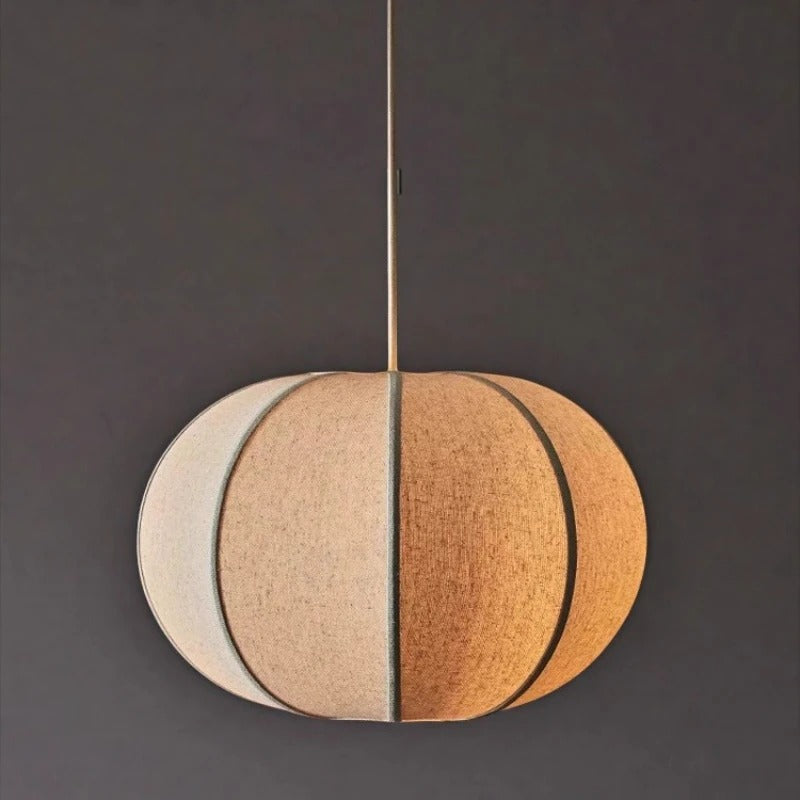 Segmented circular pendant light shade with tan and cream panels, fabric-lined cord