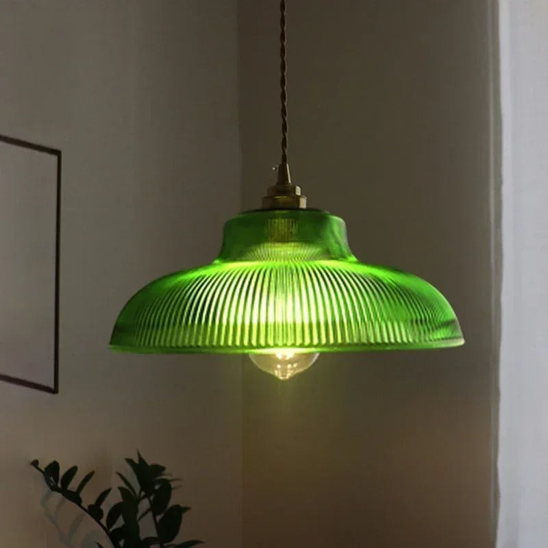 Green ribbed glass dome pendant light with brass socket and warm glow