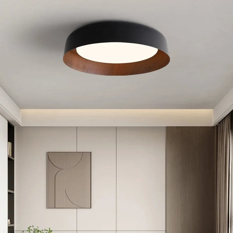 Black shallow dome ceiling light with white diffuser and wood-toned inner ring
