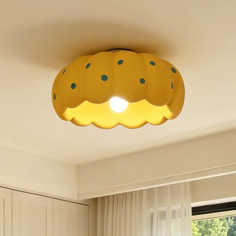 Scalloped drum ceiling light with yellow fabric shade and teal dotted pattern