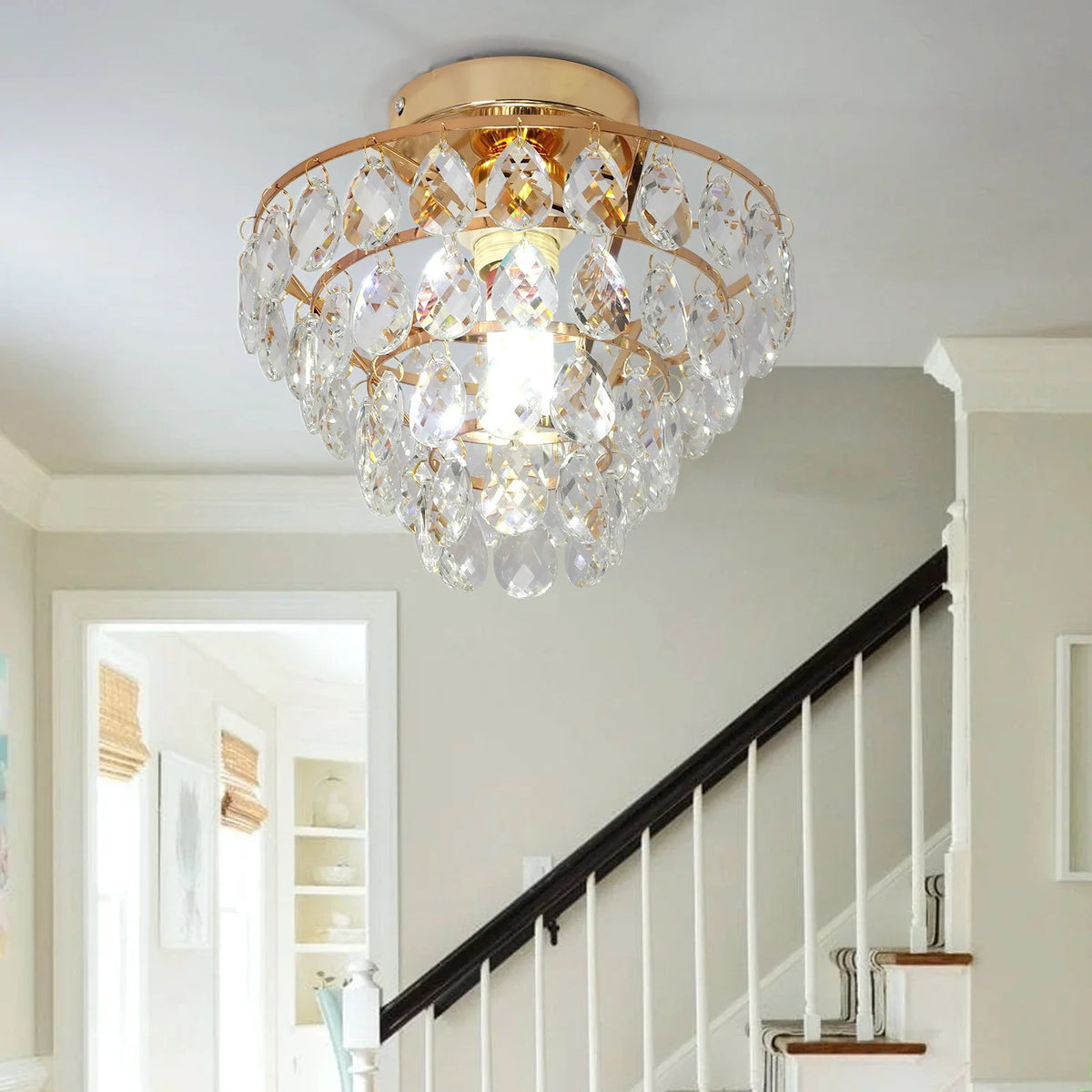 Gold ceiling light with nested crystal ring frame and clear hanging crystal prisms