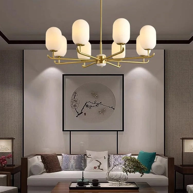 Gold multi-arm ceiling chandelier with white glass globe shades and straight center rod