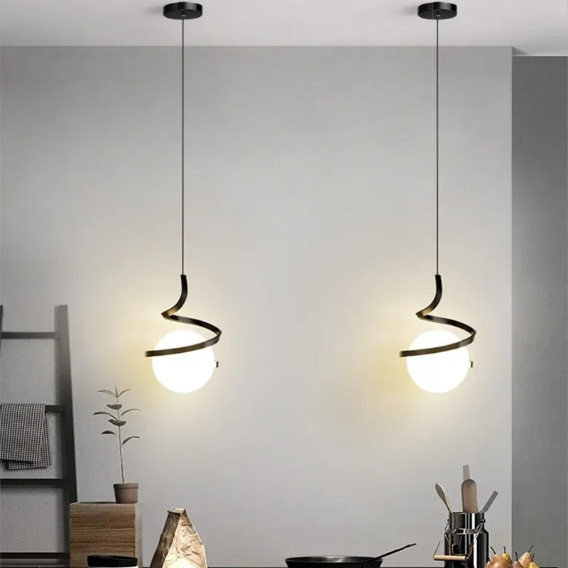 Pair of gold spiral pendant lights with white globe shades and black caps