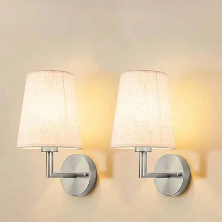 Pair of conical fabric wall lights with chrome round backplates and metal arms