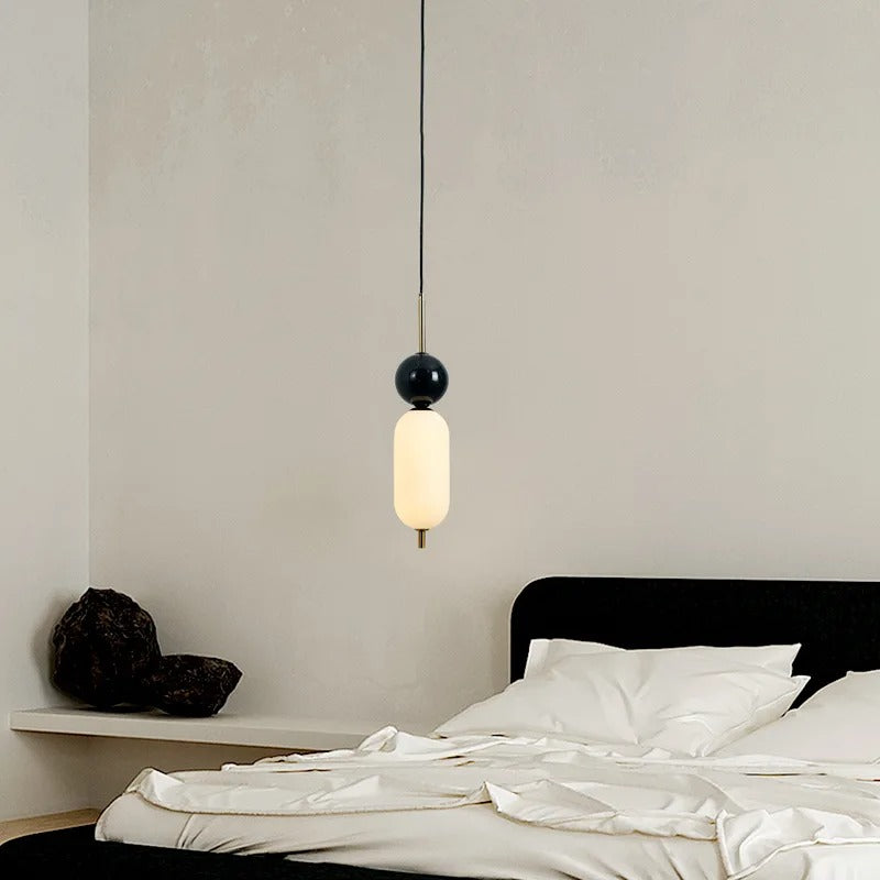 Stacked glass cylinder pendant light with dark round top, warm glow