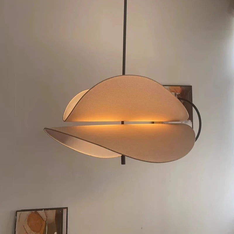 Curved layered fabric pendant light with tan shades and black mounting bracket