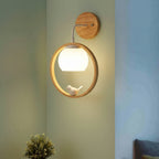 Wood halo bird wall light with glowing globe bulb and bird figure in circular ring