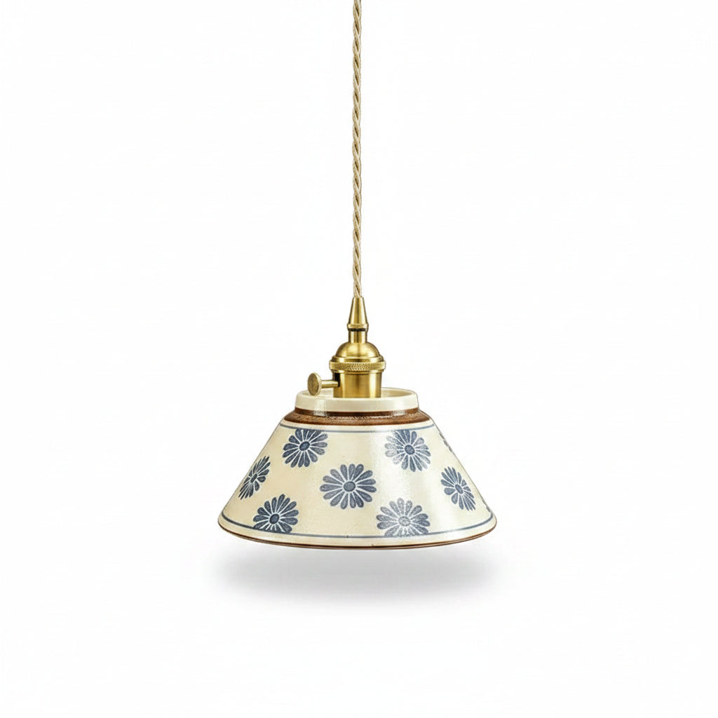 Ceramic conical pendant light with blue floral pattern shade and brass cord mount