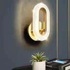 Gold textured oval wall light with bright illuminated center and glowing halo