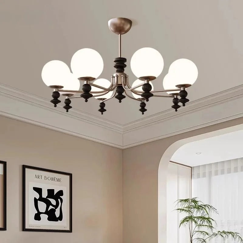 Multi-arm globe chandelier with white glass shades and bronze metal frame