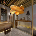Japandi wood veneer ribbon pendant light hanging from a black cord