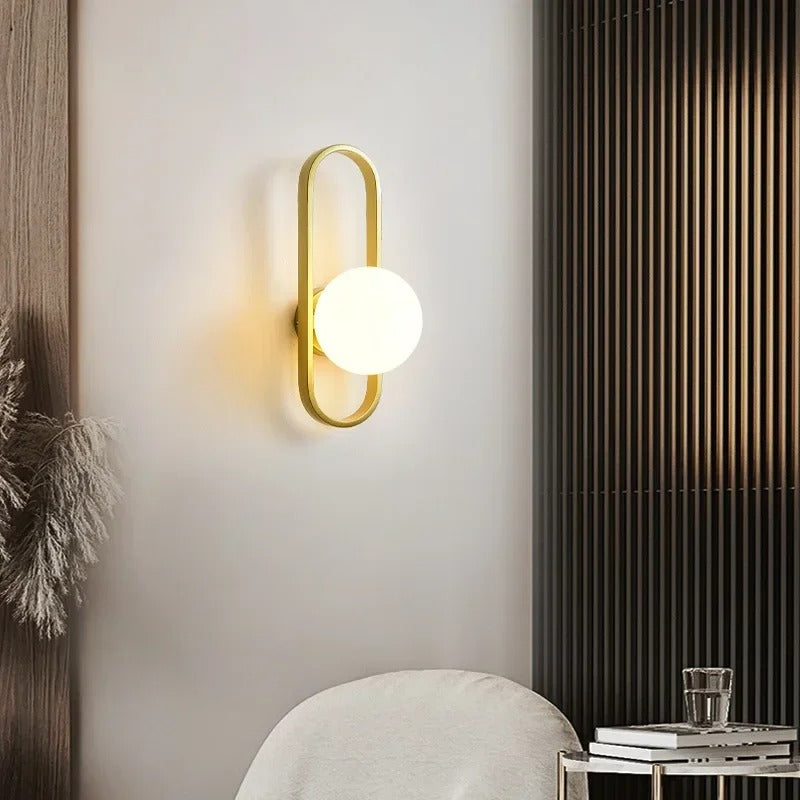 Gold oval ring globe wall light with round white glass shade